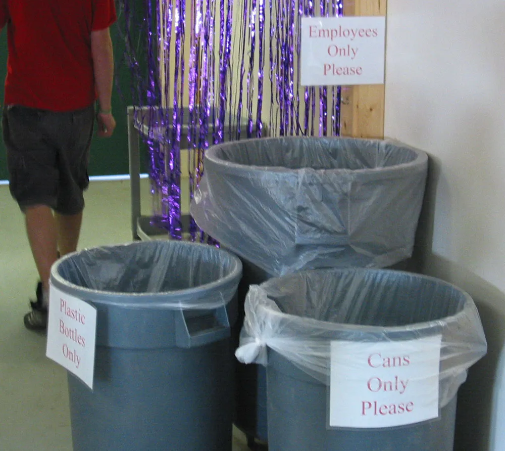 Signs on refuse cans read &#x27;Cans Only&#x27;, &#x27;Plastic Only&#x27;, and &#x27;Employees Only&#x27;.