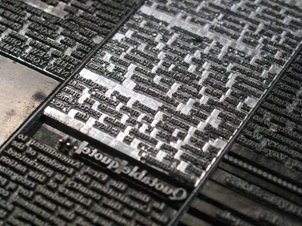 This is type. Metal type for a newspaper page.